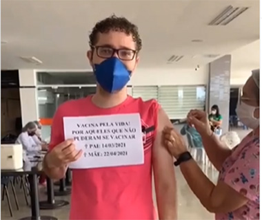 Filho que perdeu os pais para a covid se vacina e emociona com cartaz